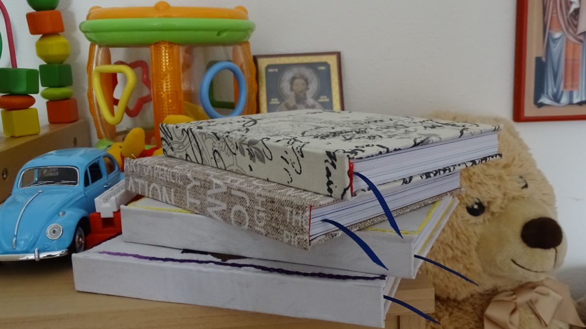 A stack of books and a teddy bear in a child’s room